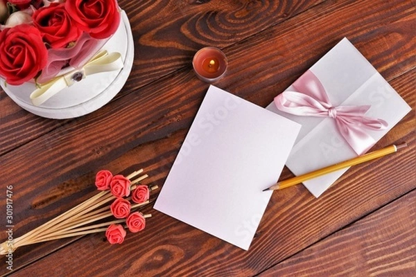 Obraz Gift box with flowers on wooden background, preparation for the holiday concept. Top view and copy area for text.