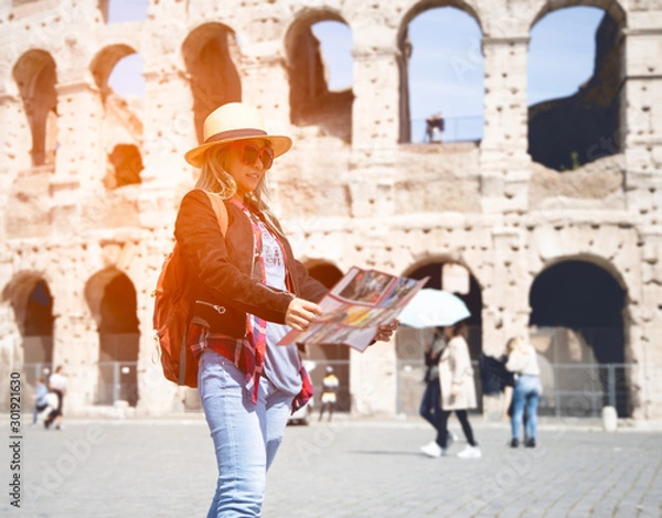 Fototapeta Woman tourist with map at Rome in front of Colosseum, Italy.
