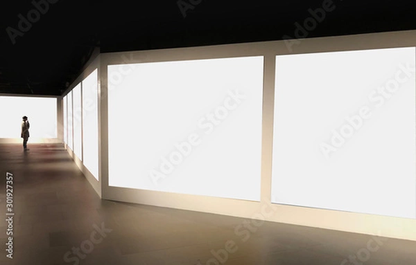 Fototapeta Perspective view of empty white space for advertisement or gallery photos line in pattern with a single man dress like artist stand and look at the first photo for mock up or use as template 