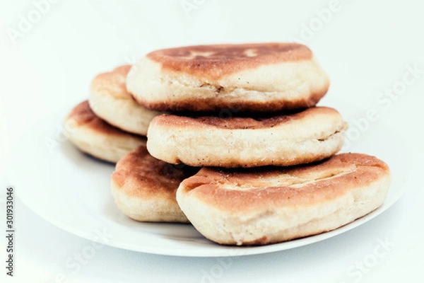 Fototapeta Fried cakes with potato and beans on white table background .