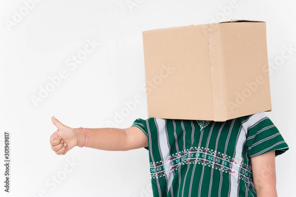 Fototapeta Young boy over isolated white background holding a box to move it to another,brown box