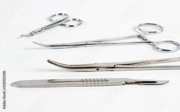 Obraz Medical instruments on a white background. Selective focus