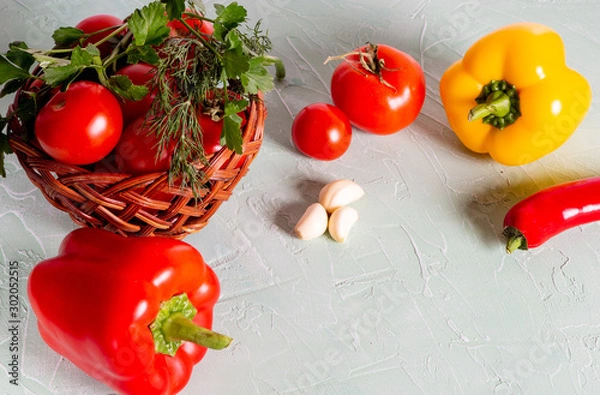 Fototapeta Basket with red tomatoes, peppers, herbs. Ingredients for cooking.