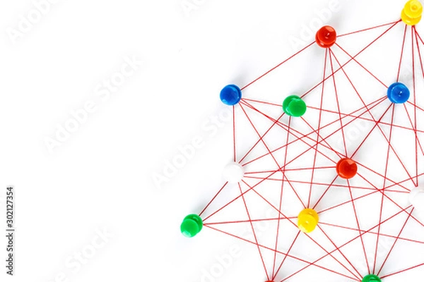 Fototapeta Network with colorful pins and string,  linked together with string on a white background suggesting a network of connections.