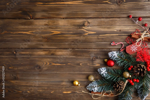 Fototapeta Fir branch with Christmas decorations on old wooden brown background with copy space for text