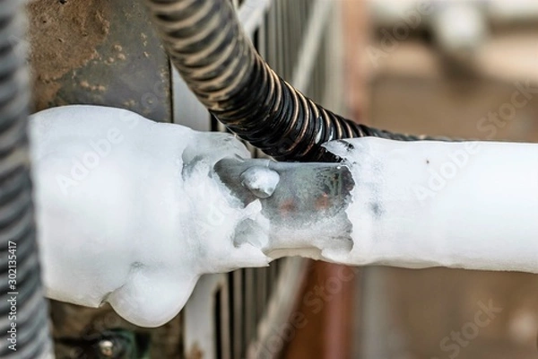 Fototapeta ac cooling air pipes covered by snow or frozen because of super performance of heavy duty central air conditioning system on the roof top in hot summer days  