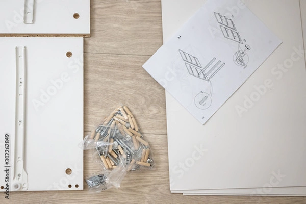 Obraz Furniture assembly parts and tools for self assembly furniture, on the floor. instructions for furniture assembling with tools