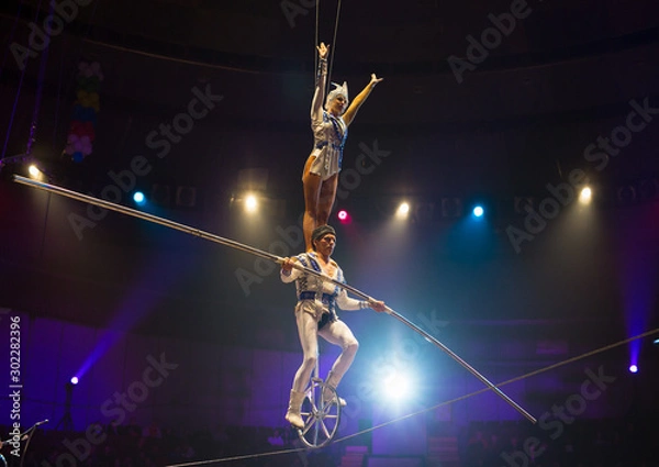 Fototapeta performance of aerialists in the circus arena.