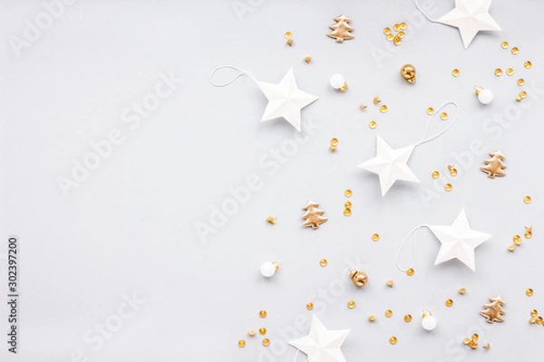 Fototapeta Gold and white christmas decoration on pastel blue background, flat lay, top view