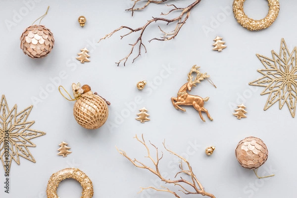 Obraz Gold christmas decoration on blue pastel background, top view, flat lay