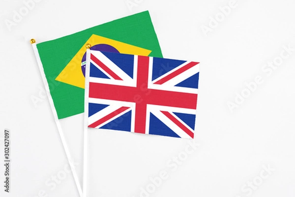 Fototapeta United Kingdom and Brazil stick flags on white background. High quality fabric, miniature national flag. Peaceful global concept.White floor for copy space.