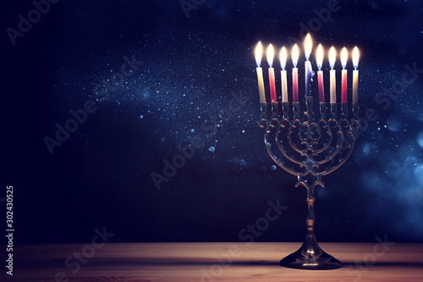 Fototapeta Religion image of jewish holiday Hanukkah background with menorah (traditional candelabra) and candles