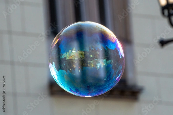 Fototapeta Close up of the colorful soap bubble in the bright autumn day, during independence in Wroclaw,