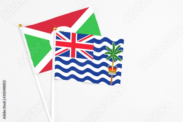 Fototapeta British Indian Ocean Territory and Burundi stick flags on white background. High quality fabric, miniature national flag. Peaceful global concept.White floor for copy space.