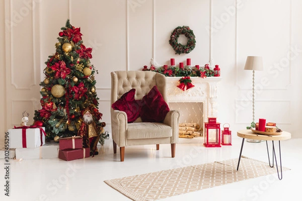 Fototapeta Christmas interior with christmas tree and a fireplace in traditional red color. Beautiful christmas decor. Happy new year concept.