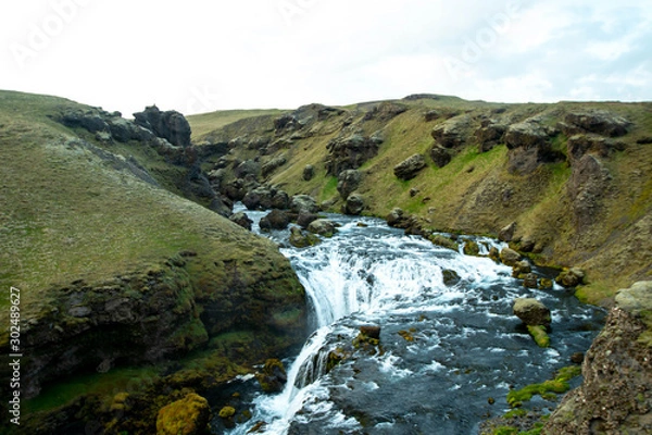 Fototapeta River leading towards Skogafoss late in the evening during summer