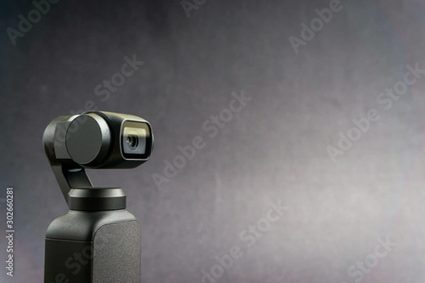 Obraz KUALA LUMPUR, MALAYSIA - November 13, 2019 : DJI Osmo Pocket stabilized handheld camera close up on black background. Selective focus and crop fragment