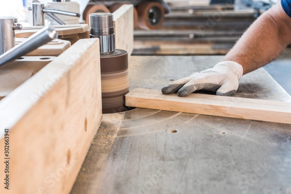 Obraz carpenter is polishing up a wooden board