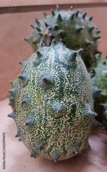 Fototapeta kiwano or horned melon, spiked melon, also African horned cucumber or melon, jelly melon, hedged gourd, melano
