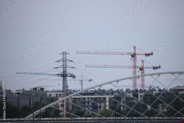 Obraz tower construction cranes on the background of houses