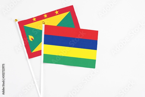 Fototapeta Mauritius and Grenada stick flags on white background. High quality fabric, miniature national flag. Peaceful global concept.White floor for copy space.