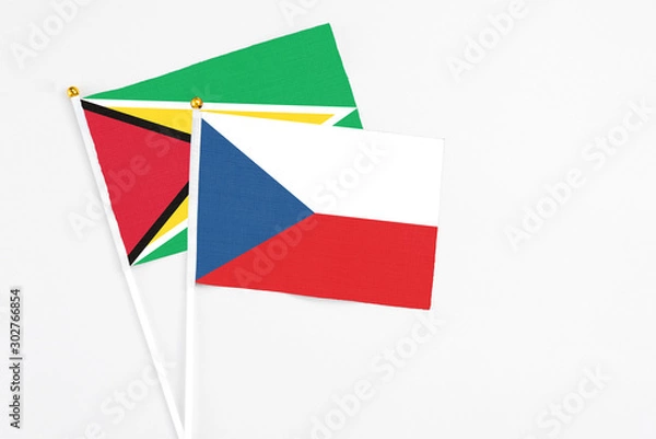 Obraz Czech Republic and Guyana stick flags on white background. High quality fabric, miniature national flag. Peaceful global concept.White floor for copy space.