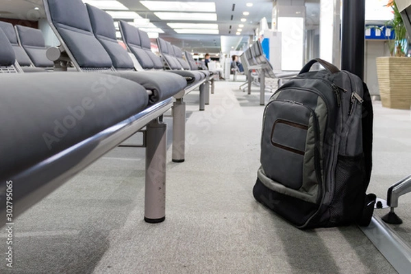 Obraz Unattended cabin backpack abandoned on the floor at the boarding waiting hall of an airport.