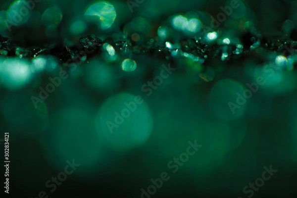 Fototapeta Monochrome emerald abstract background with bokeh defocused lights.