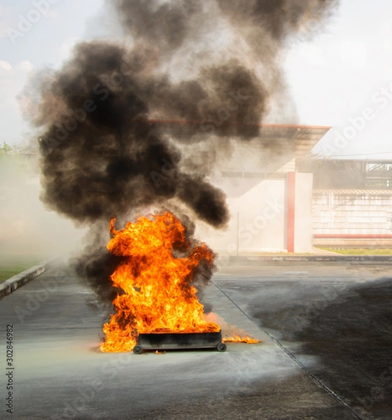Fototapeta Fire drills using fuel as fuse. The fires caused by oil are very severe. The blaze was red and yellow. Firefighting is required to use chemicals from the fire extinguisher. For extinguishing fires.
