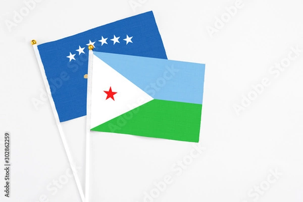 Fototapeta Djibouti and Kosovo stick flags on white background. High quality fabric, miniature national flag. Peaceful global concept.White floor for copy space.