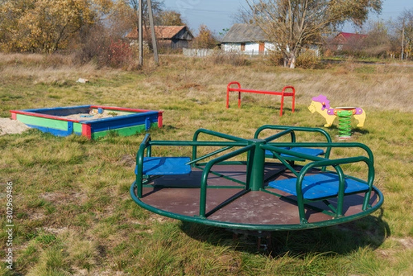 Fototapeta Playground in the countryside, with different types of swings and swings for children.