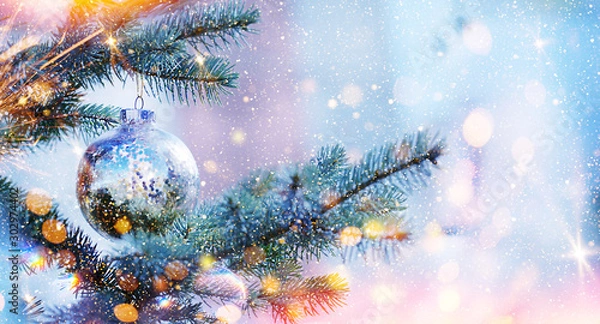 Fototapeta Christmas and New Year holidays background. Glitter lights backdrop. Winter season. Text space. Closeup of Christmas-tree.