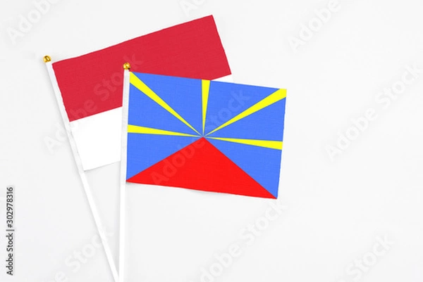 Obraz Reunion and Monaco stick flags on white background. High quality fabric, miniature national flag. Peaceful global concept.White floor for copy space.