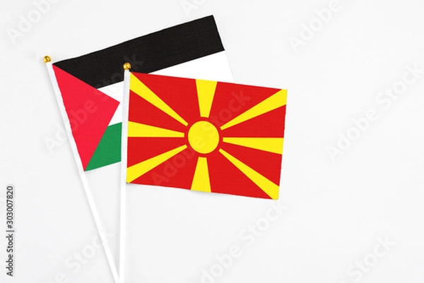 Fototapeta Macedonia and Palestine stick flags on white background. High quality fabric, miniature national flag. Peaceful global concept.White floor for copy space.