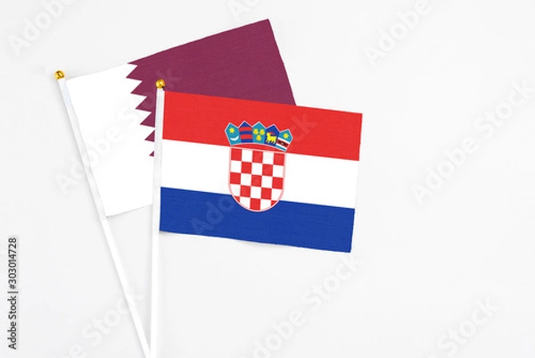Fototapeta Croatia and Qatar stick flags on white background. High quality fabric, miniature national flag. Peaceful global concept.White floor for copy space.