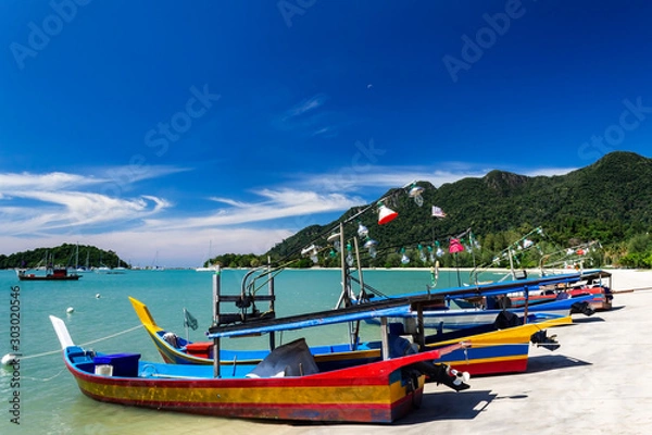 Fototapeta Telaga Harbor beach with colourful squid fishing boats on Langkawi island, also known as Pulau Langkawi, Andaman Sea, State of Kedah, Malaysia.