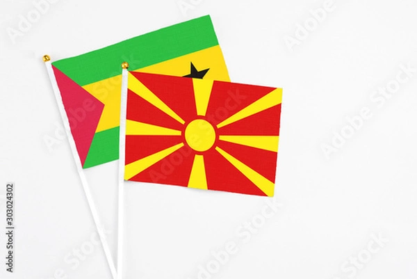 Fototapeta Macedonia and Saudi Arabia stick flags on white background. High quality fabric, miniature national flag. Peaceful global concept.White floor for copy space.
