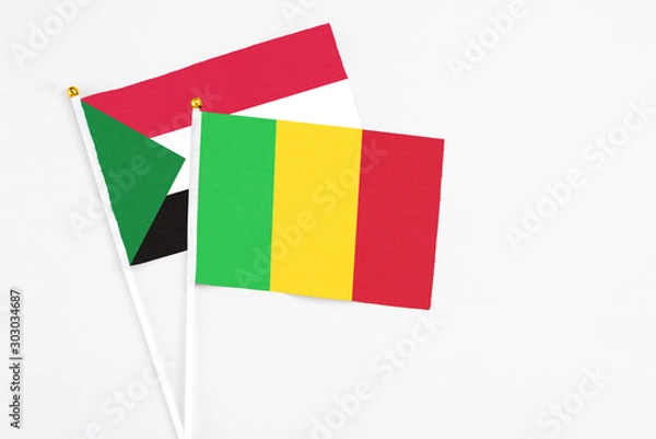 Fototapeta Mali and Sudan stick flags on white background. High quality fabric, miniature national flag. Peaceful global concept.White floor for copy space.