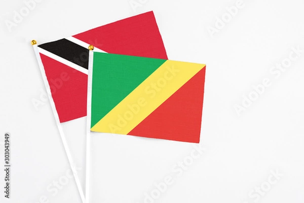 Fototapeta Republic Of The Congo and Trinidad And Tobago stick flags on white background. High quality fabric, miniature national flag. Peaceful global concept.White floor for copy space.