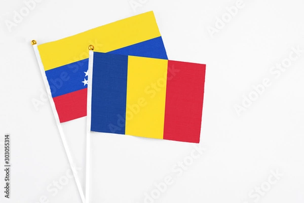 Fototapeta Romania and Venezuela stick flags on white background. High quality fabric, miniature national flag. Peaceful global concept.White floor for copy space.