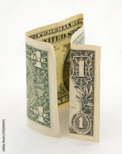 Obraz One folded dollar on a light background.