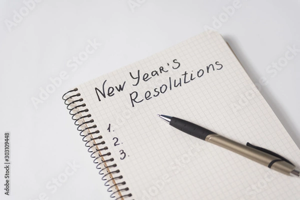 Obraz Phrase New Year's resolutions in the notebook and blank page, pen.