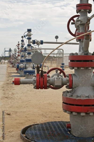 Fototapeta Well in a row on multiple well platform