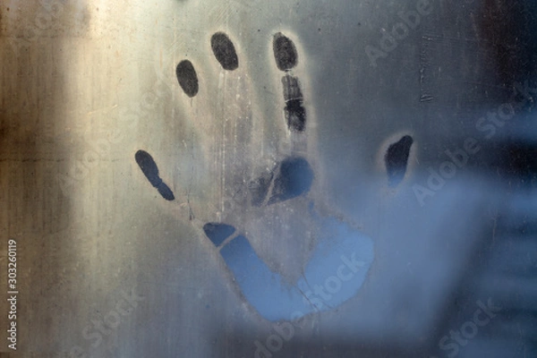 Fototapeta a handprint on the fogged glass