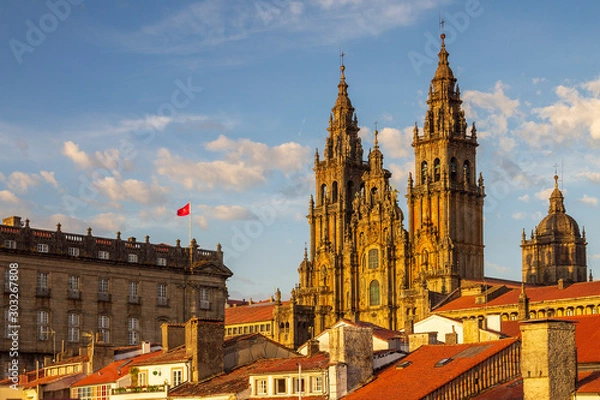 Fototapeta Santiago de Compostela Cathedral Towers Close Up with Sun Light Hitting the facade and Tiled Roofs La Coruña Galicia