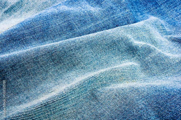 Fototapeta clothing items blue stonewashed faded jeans cotton fabric texture with seams, clasps, buttons and rivets, macro, close-up