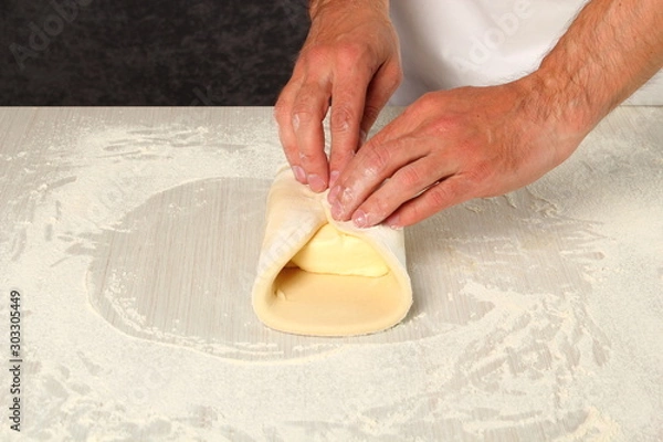 Fototapeta Making Puff Pastry. Bring dough to centre of butter to enclose it completely.