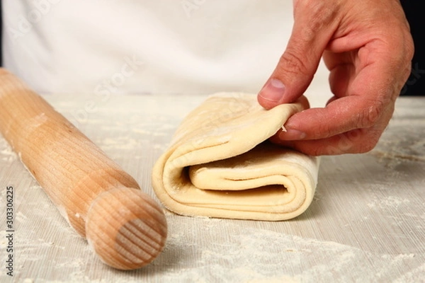 Fototapeta Making Puff Pastry. Folding lower third of dough over centre third and top third  down over that. Next Step.