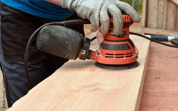 Fototapeta Sanding With Electric orbital sander.