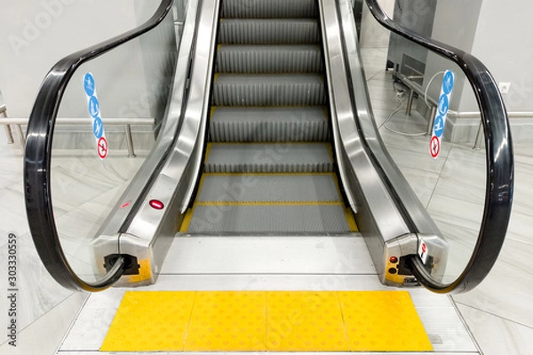 Obraz modern people-free escalator with tiles for the blind